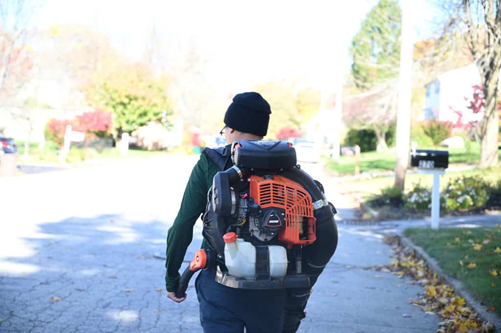Employee walking with leaf blower
