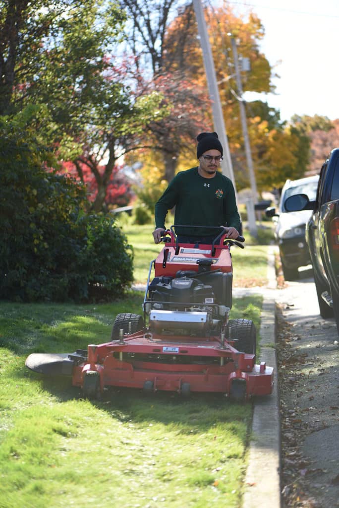 Employee mowing yard