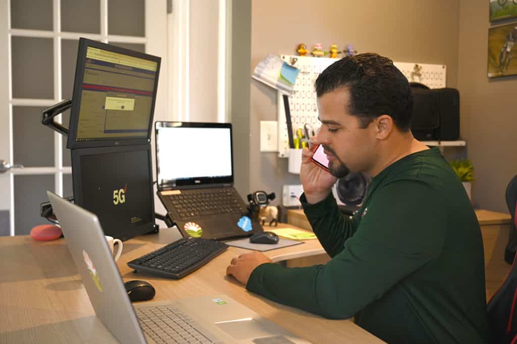 The owner talking on the phone at his desk
